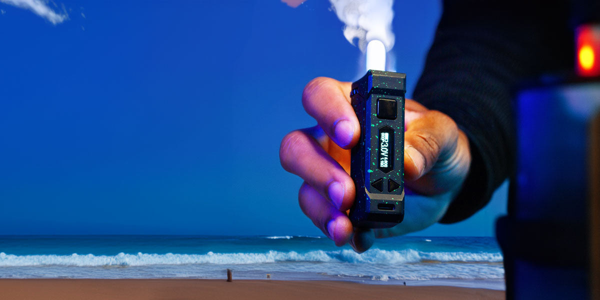 Man holding Wulf UNI Pro in front of beach scene and blue skies